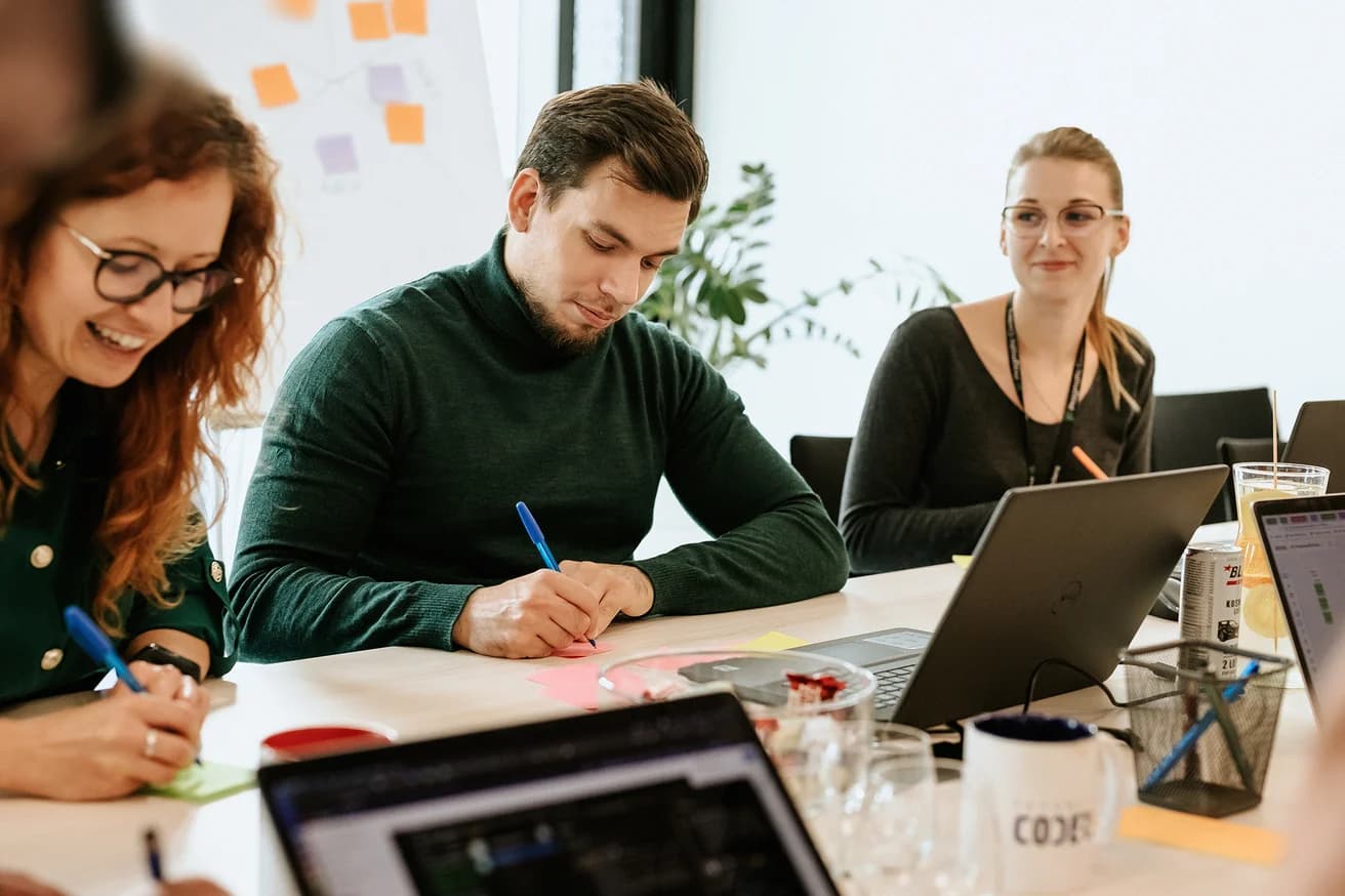 The Pragmatic Coders team during a workshop around a shared table